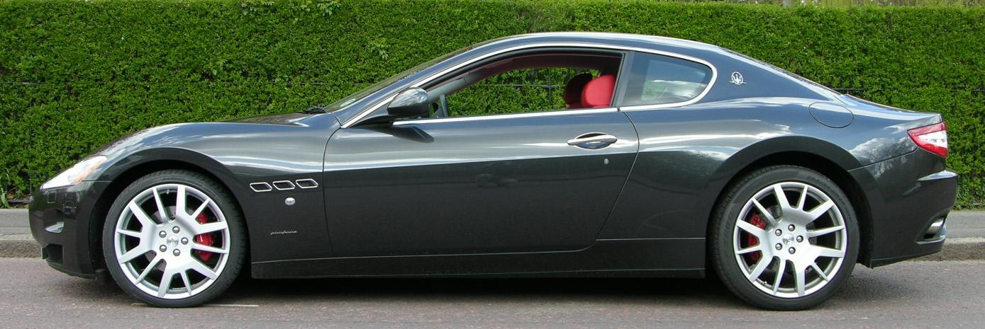 Side profile of a sleek coupe with alloy wheels and red brake calipers