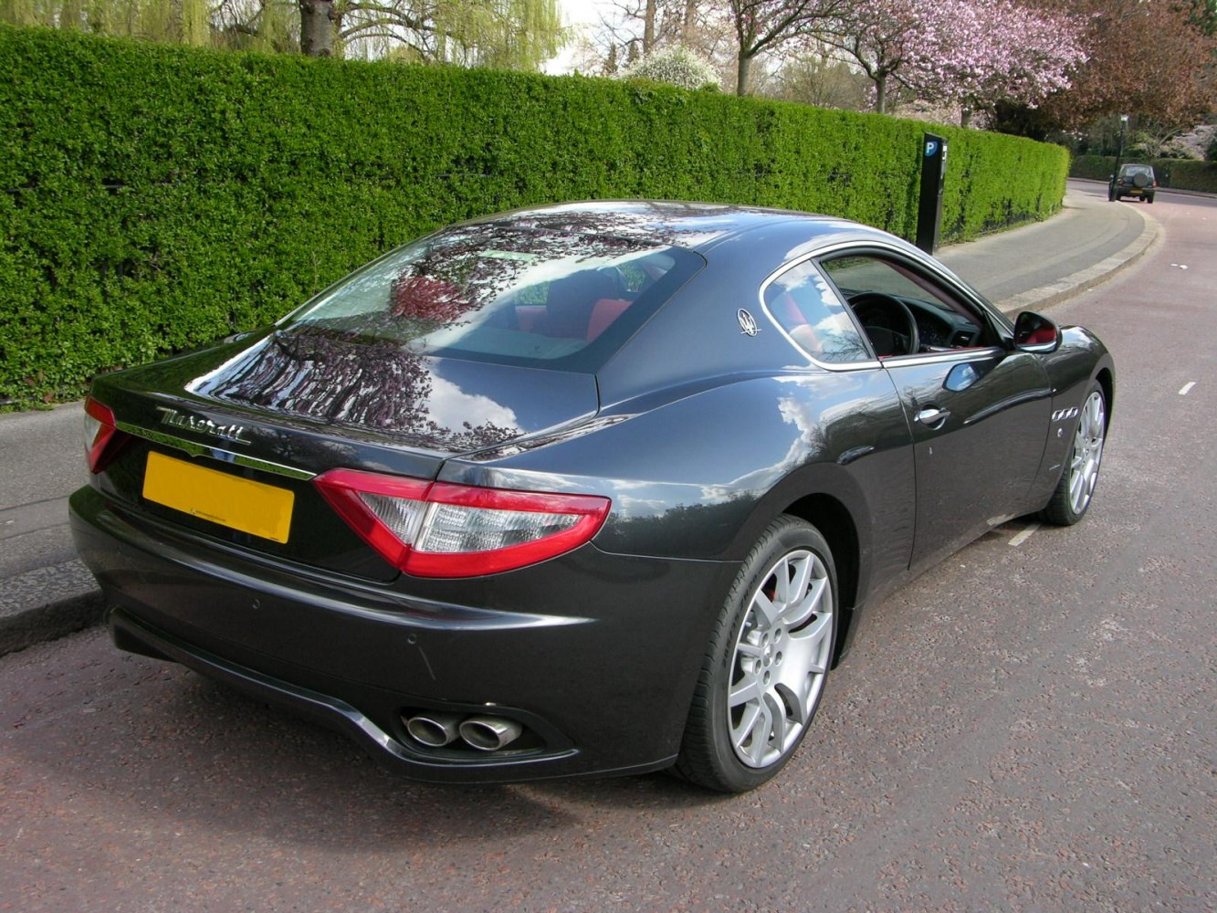 Rear-angle coupe with quad exhausts and silver multi-spoke wheels