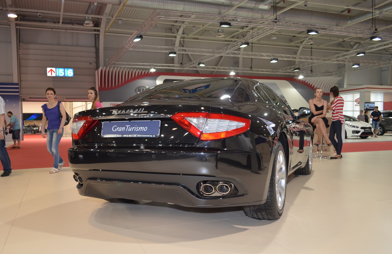 Rear view of luxury car with quad exhaust and distinctive taillights