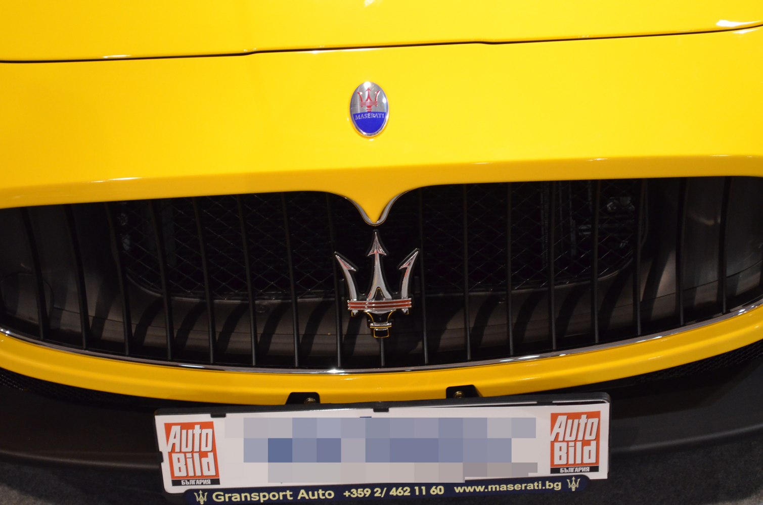 Front grille with Maserati trident badge on yellow body