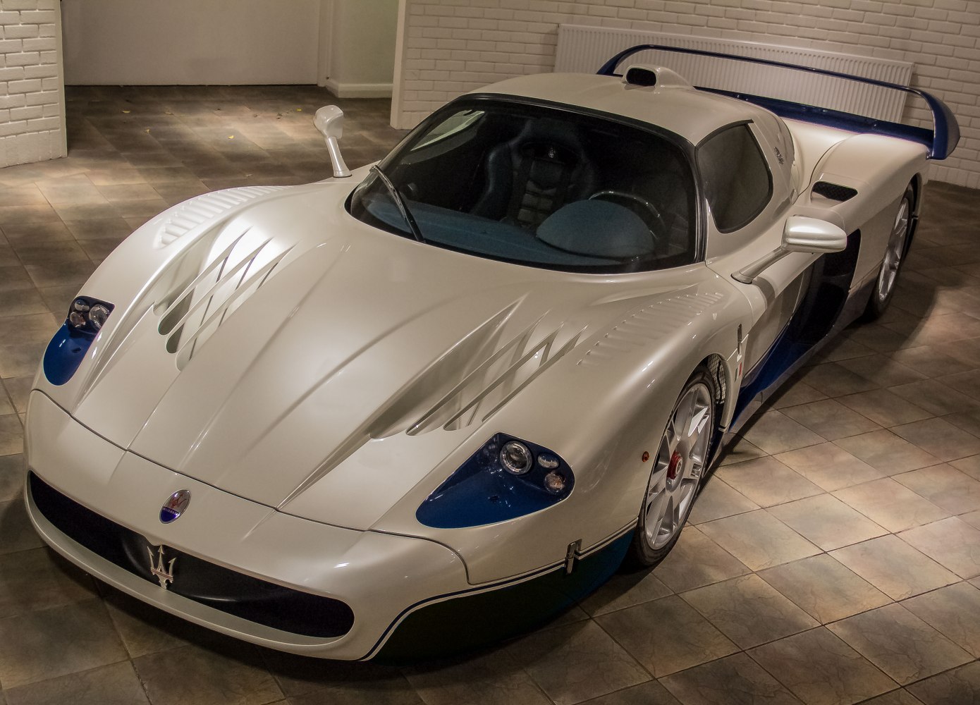 Aerodynamic hood vents and rear wing spoiler on a sleek sports coupe.