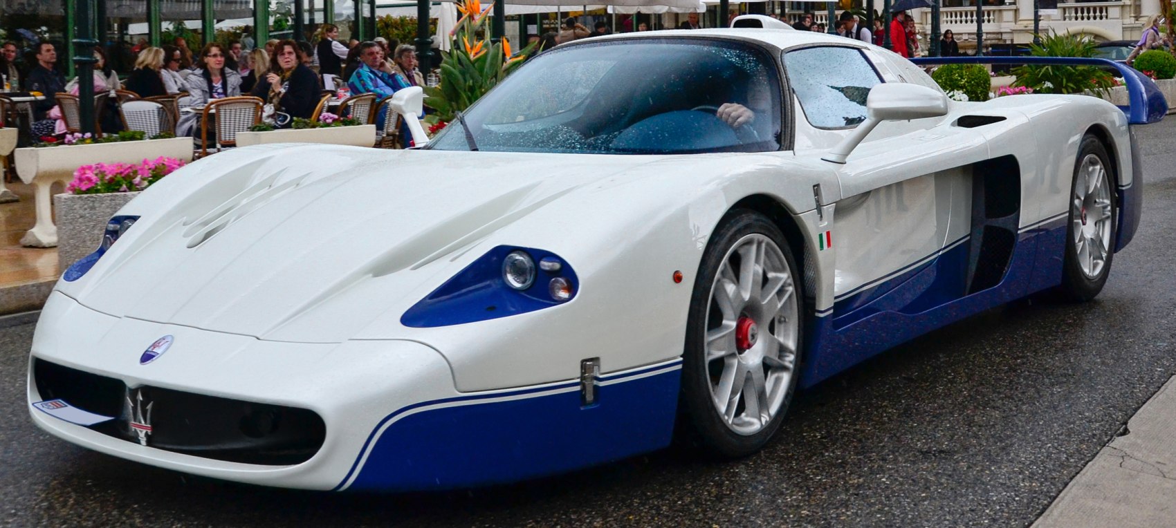 Aerodynamic white and blue sports car with vented hood and racing rims