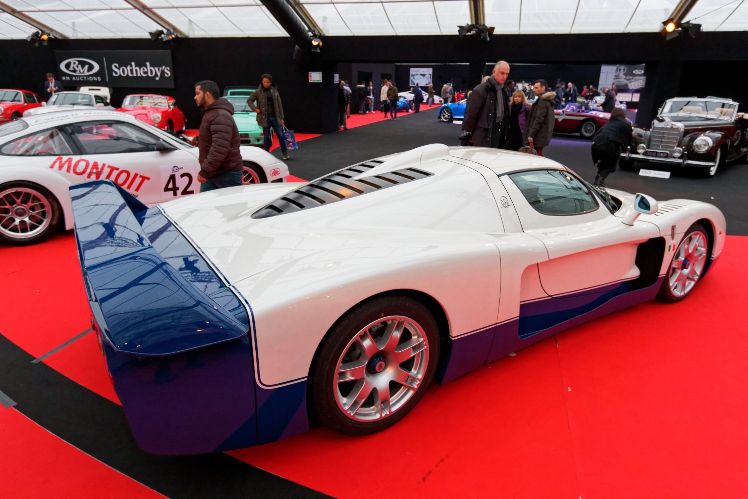 Rear side profile with large rear wing and aerodynamic design.