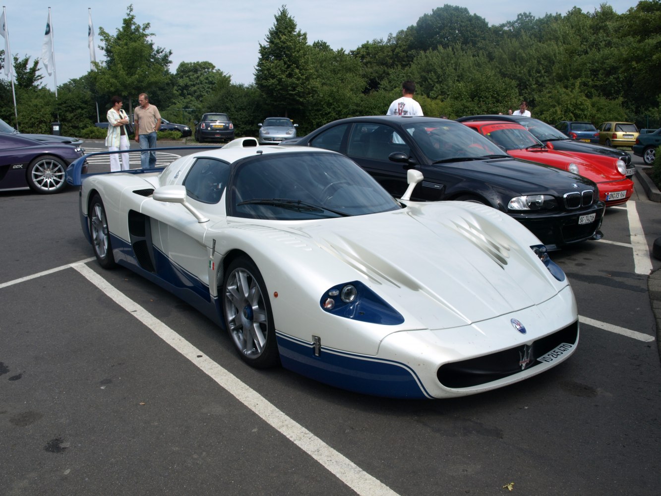 Sleek aerodynamic white and blue supercar with distinctive headlights and racing-inspired bodywork