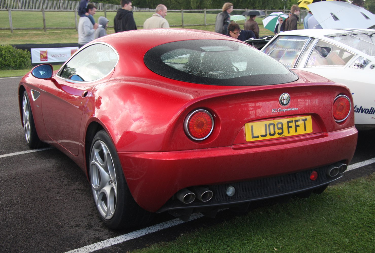 Rear view of car with round taillights and quad exhaust pipes