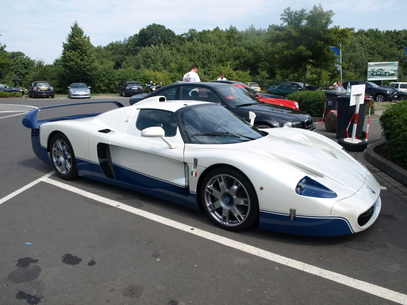 White and blue supercar with aerodynamic design and rear wing
