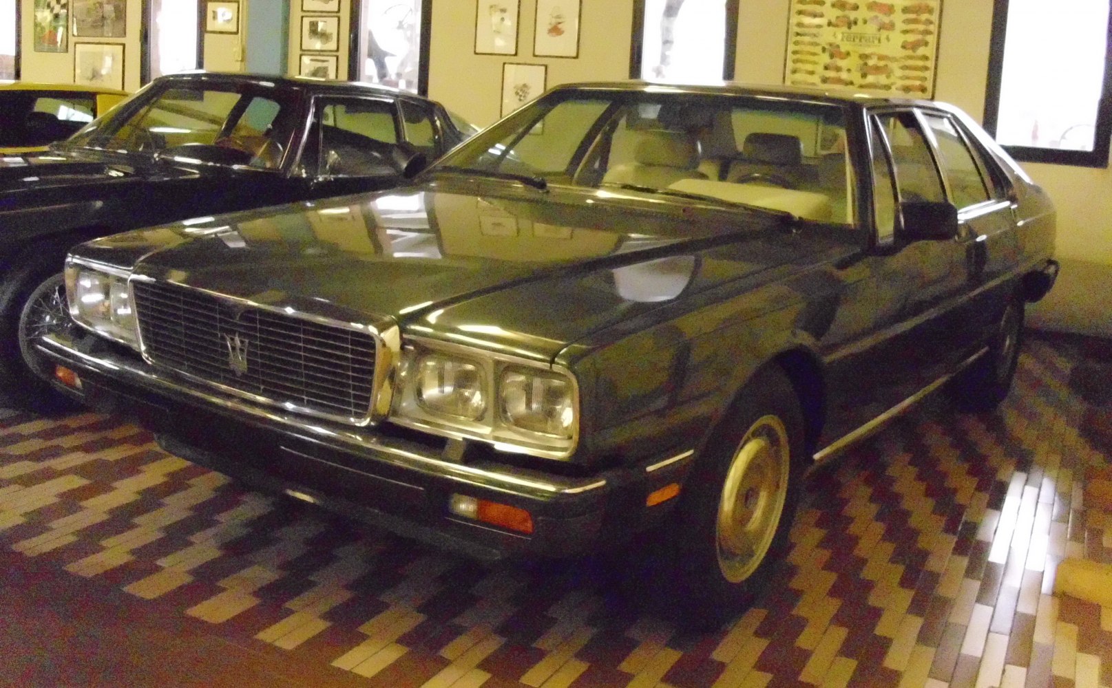 Rectangular quad headlights and a chrome-trimmed front grille of a vintage luxury sedan