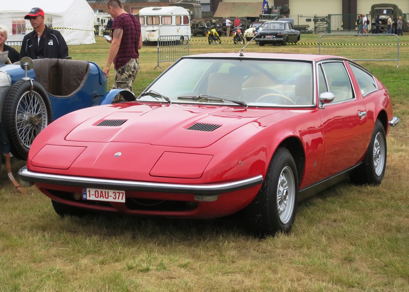 Front view of a sleek vintage coupe with pop-up headlights and sporty hood details.