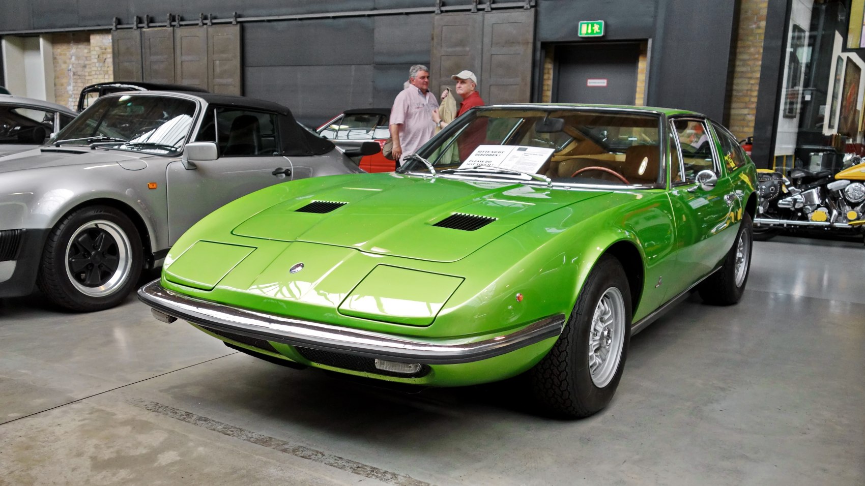 Green classic sports coupe with pop-up headlights