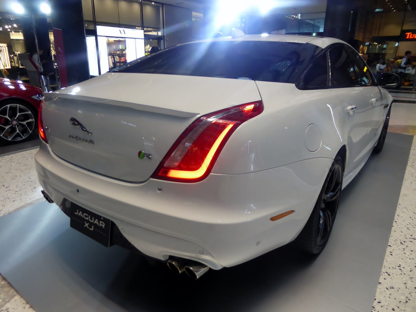 Jaguar luxury sedan rear with unique tail lights and dual exhaust pipes