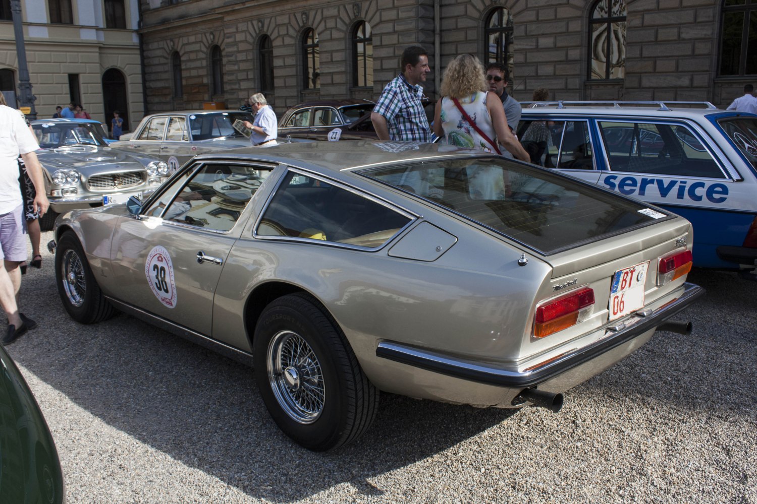 Vintage sports coupe with wire wheels and prominent rear hatchback