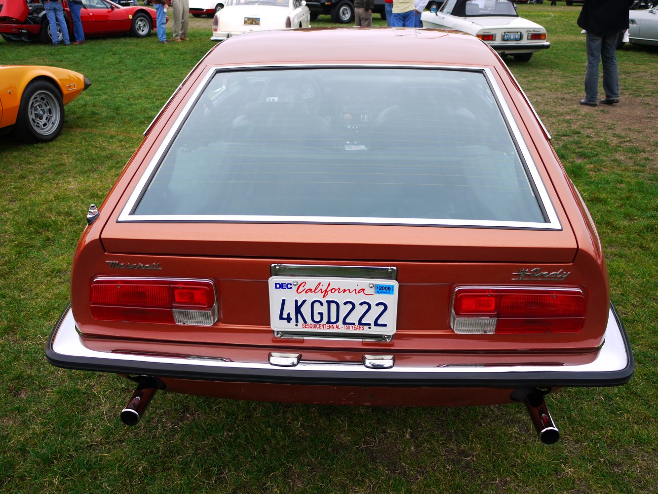 Rear view of vintage coupe with distinctive taillights and chrome bumper