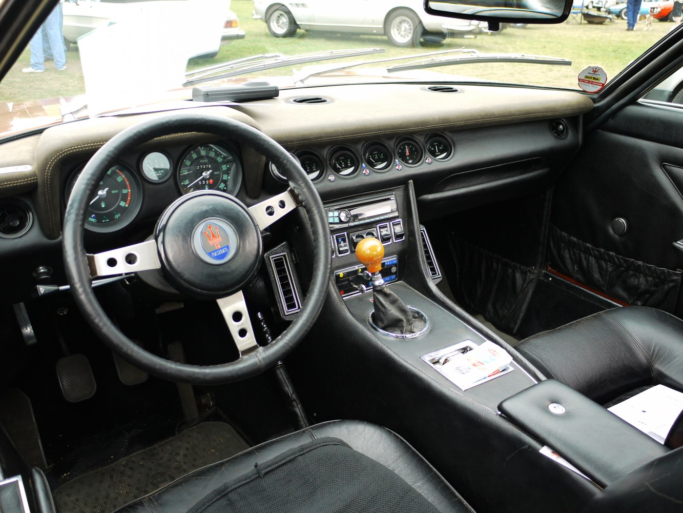 Classic vintage car interior with wooden gear shift and analog gauges