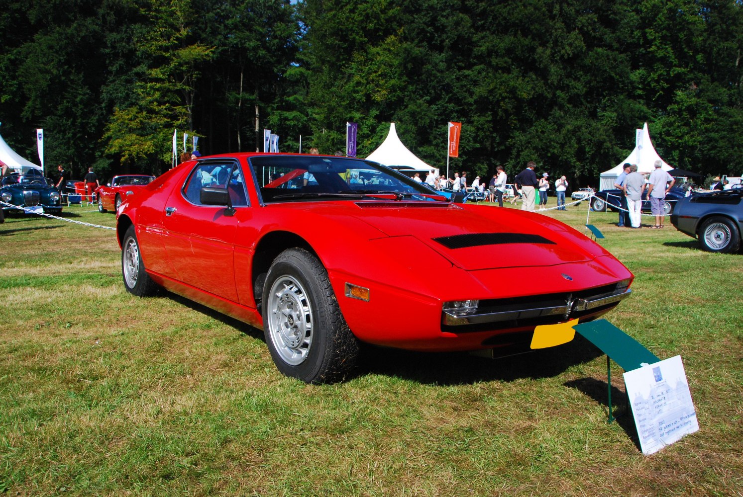 Red vintage sports coupe with sleek body and classic front design