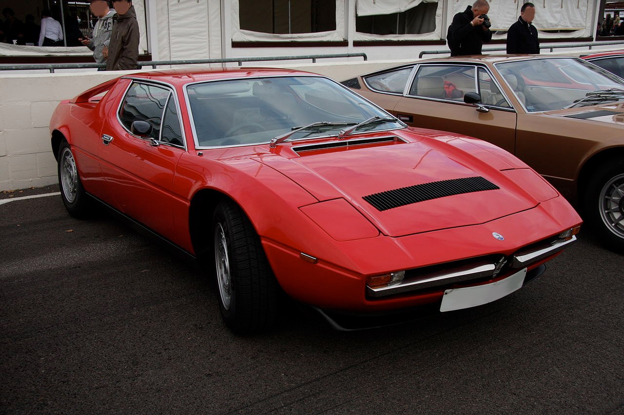 Vintage sports coupe with pop-up headlights and vented hood
