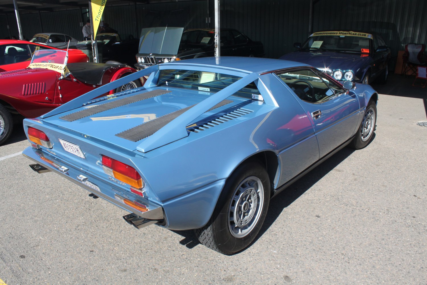 Mid-engine sports car with distinctive rear struts and classic alloy wheels