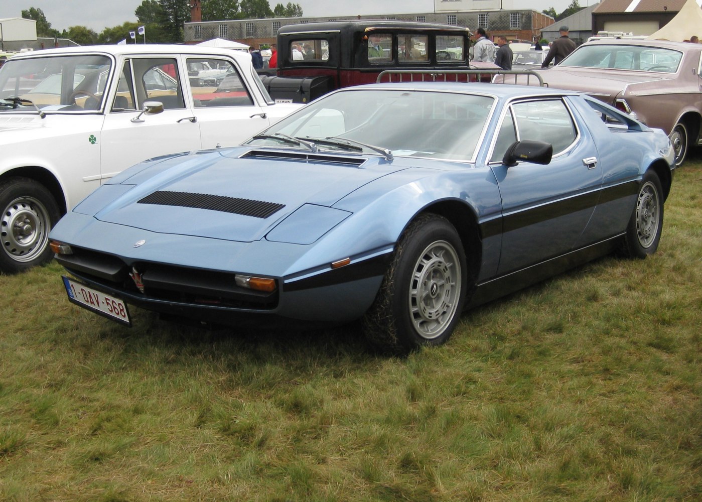 Sharp aerodynamic front and curved body blue classic sports coupe.