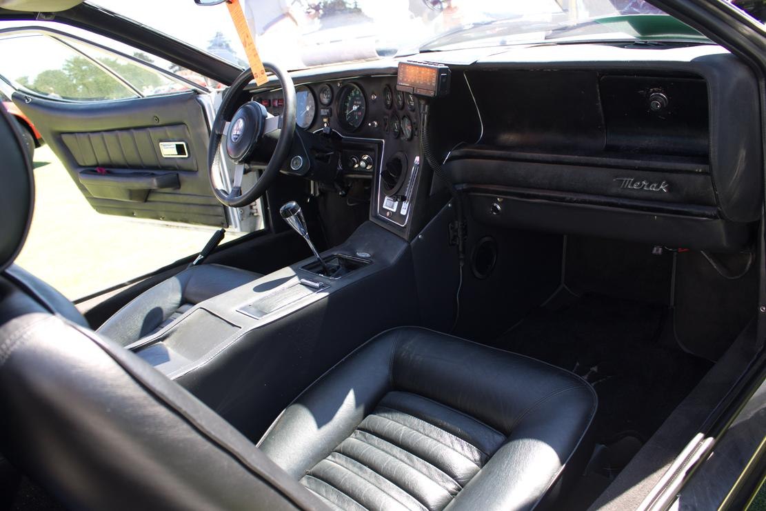 Vintage sports car interior with manual gear shifter and black leather seats