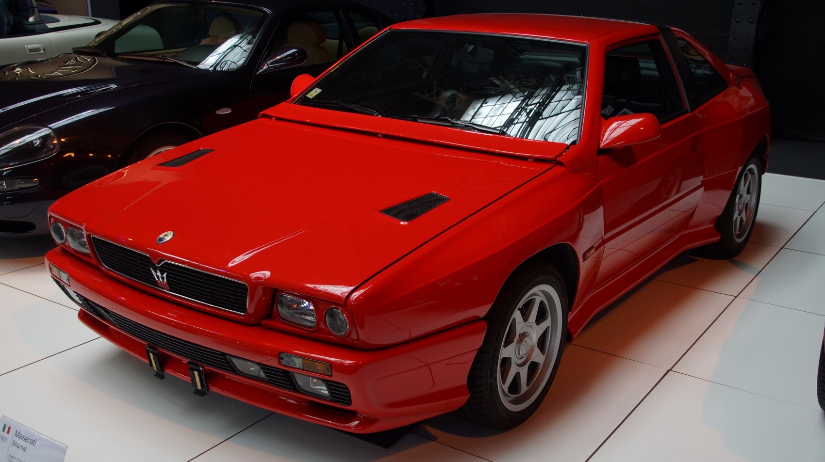 Red sports coupe with iconic grille and aerodynamic front design