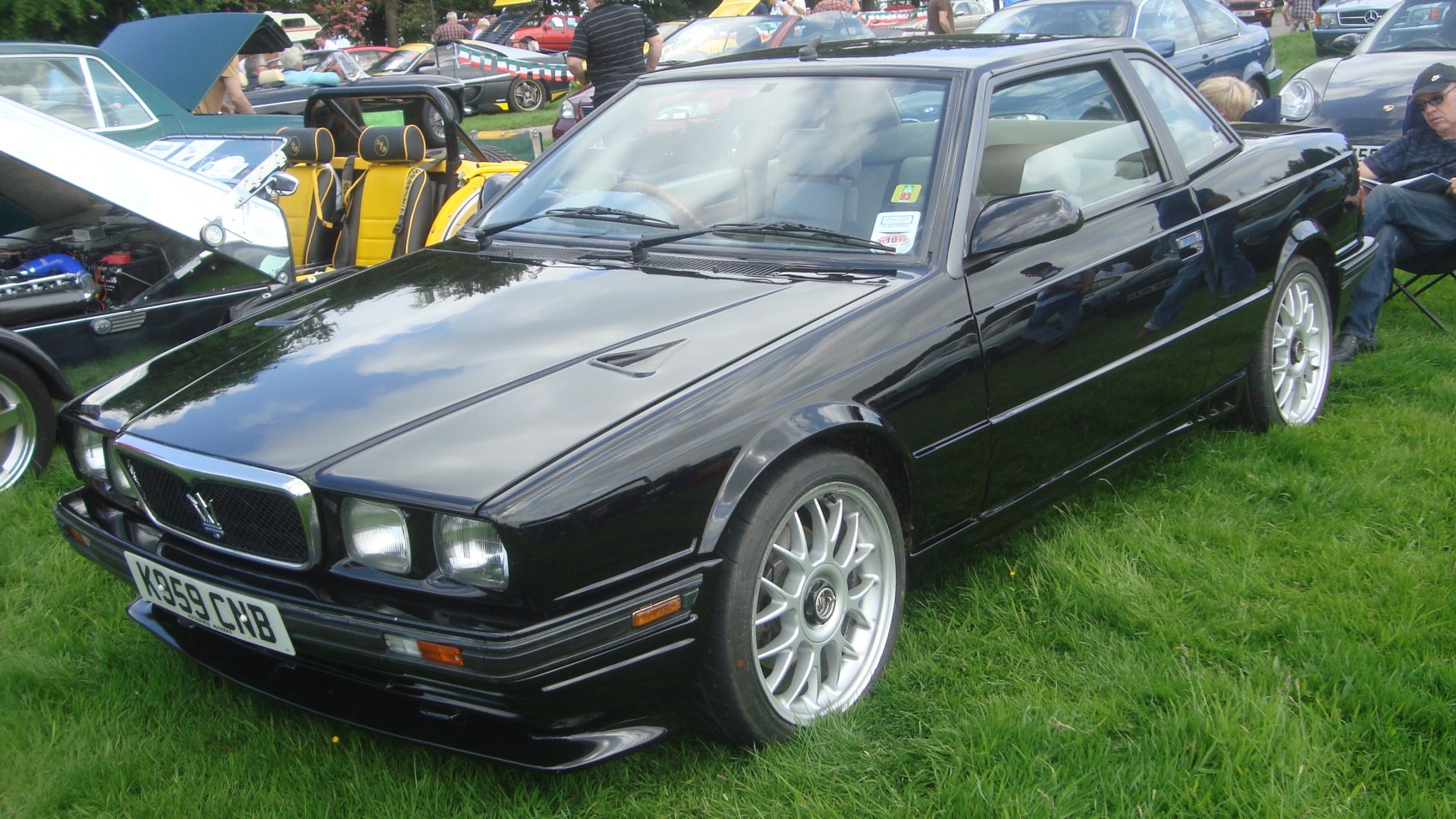 Black coupé with dual rectangular headlights and silver alloy wheels