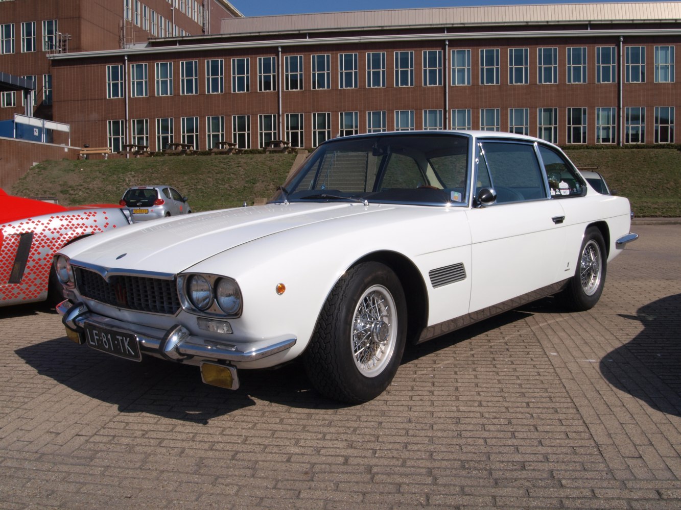 Luxury coupe with wire wheels and quad round headlights