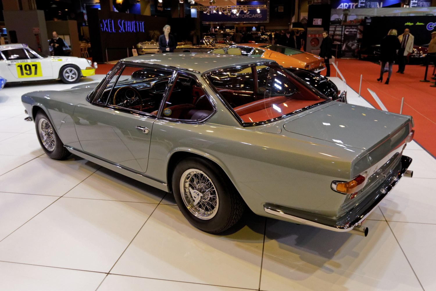 1960s two-door coupe with wire-spoke wheels and chrome trim