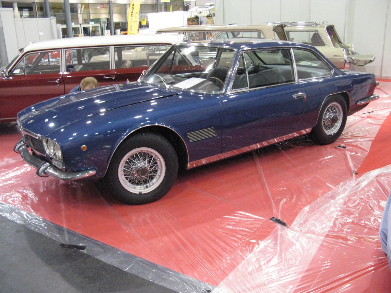Two-door coupe with wire-spoke wheels and chrome bumpers.