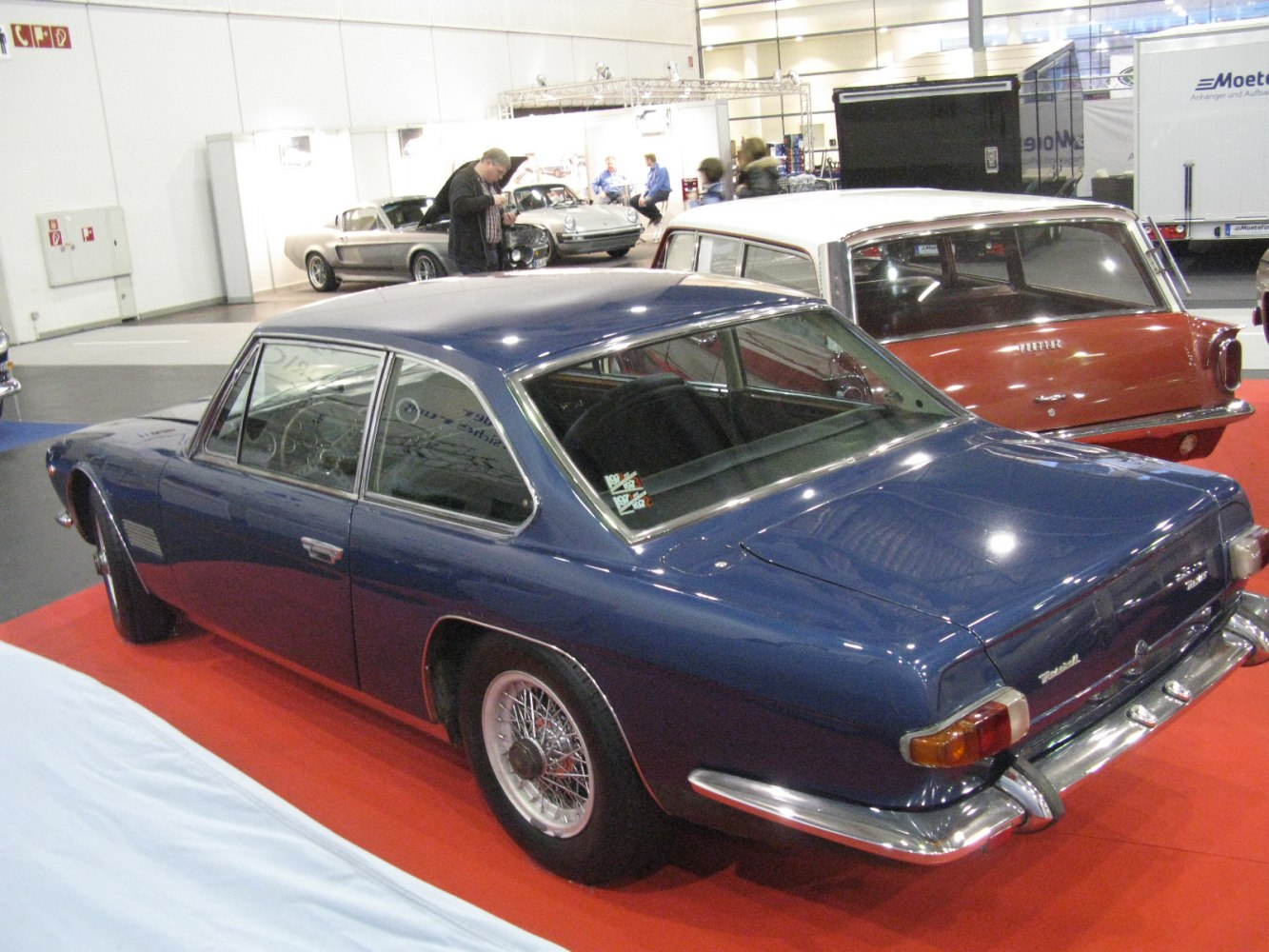 Vintage coupe rear side view with wire wheels and classic 1960s design
