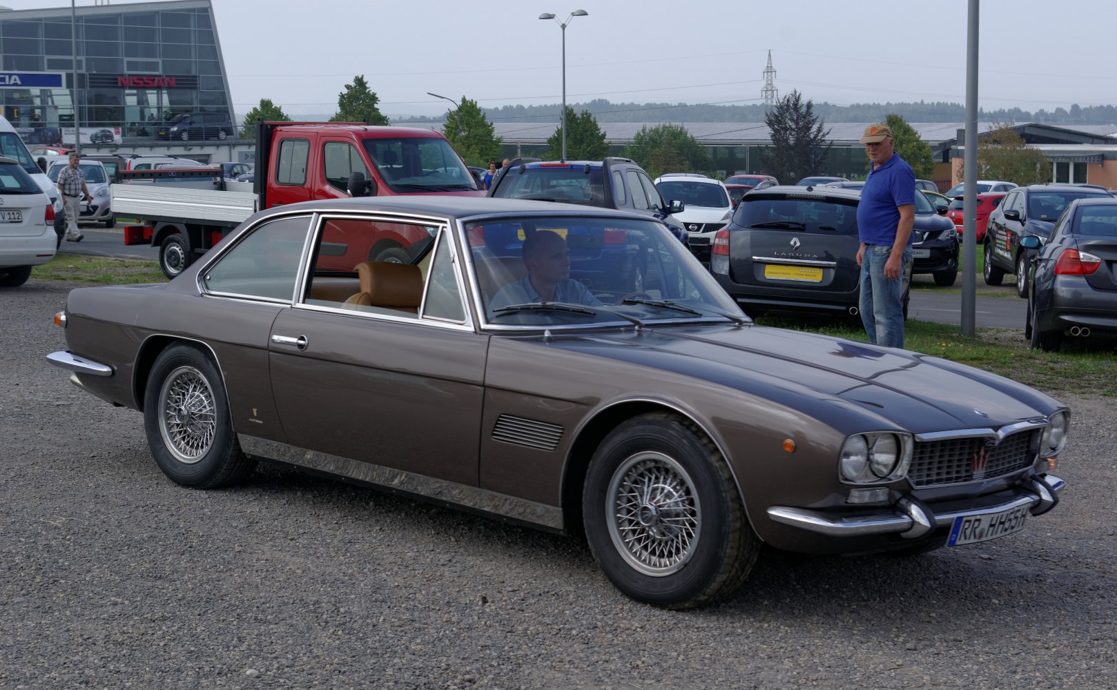 Luxury sports coupe with wire-spoke wheels and chrome bumpers