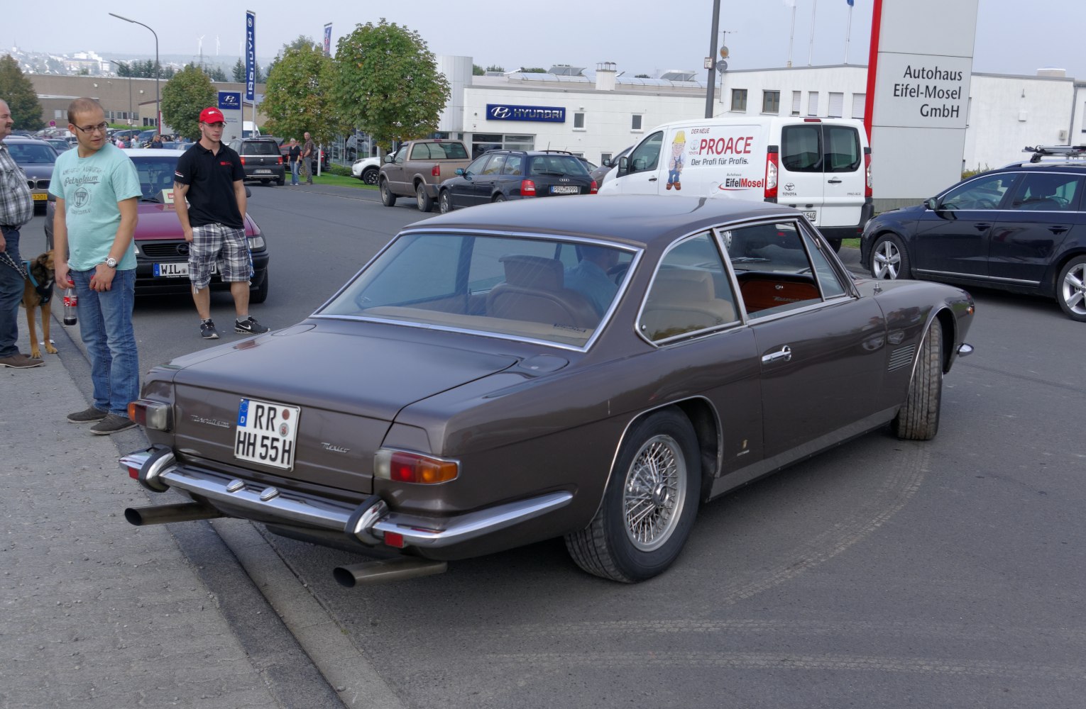 Rear and side view of vintage coupe with wire wheels and chrome bumper