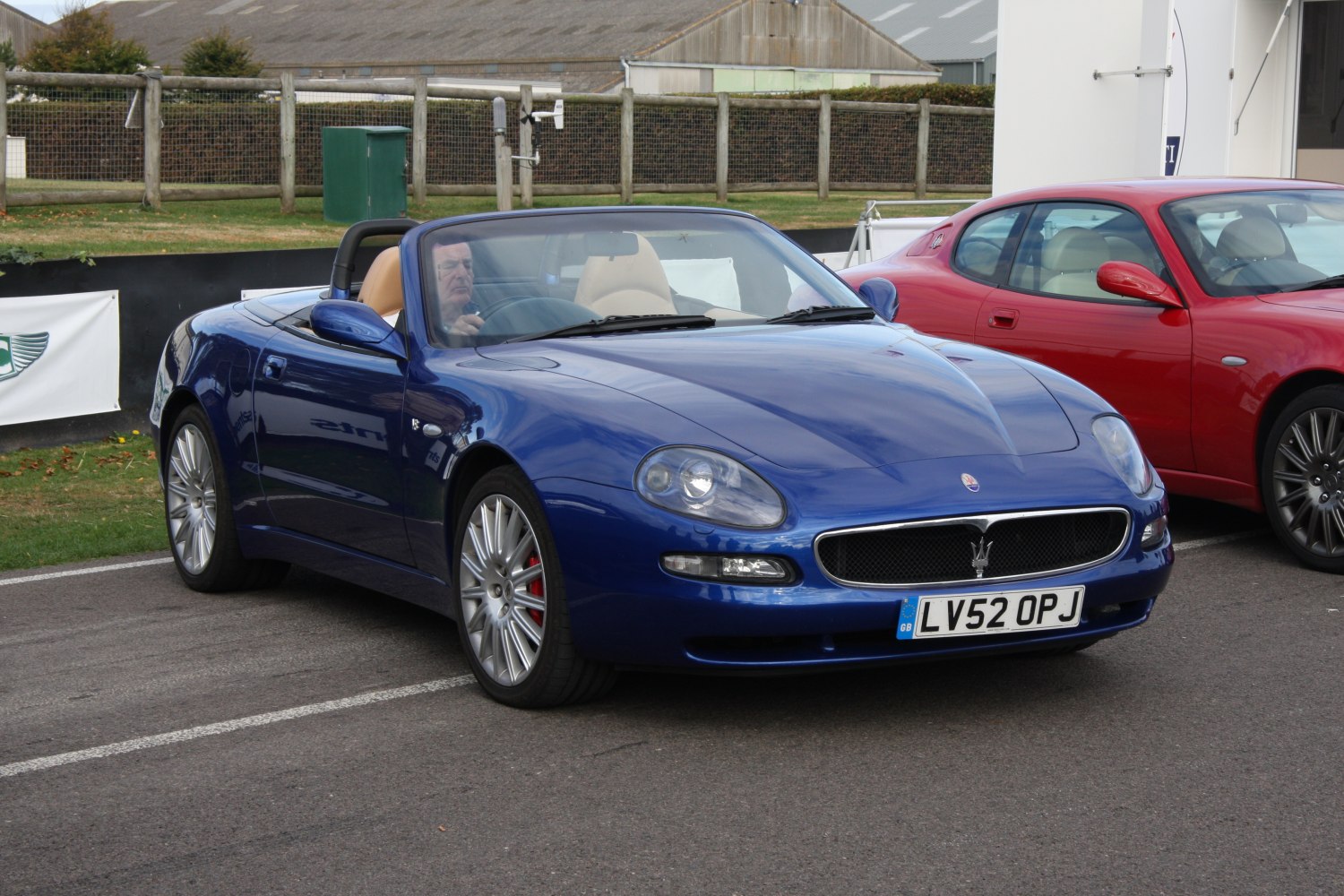 Blue convertible front view with alloy wheels and sleek headlights