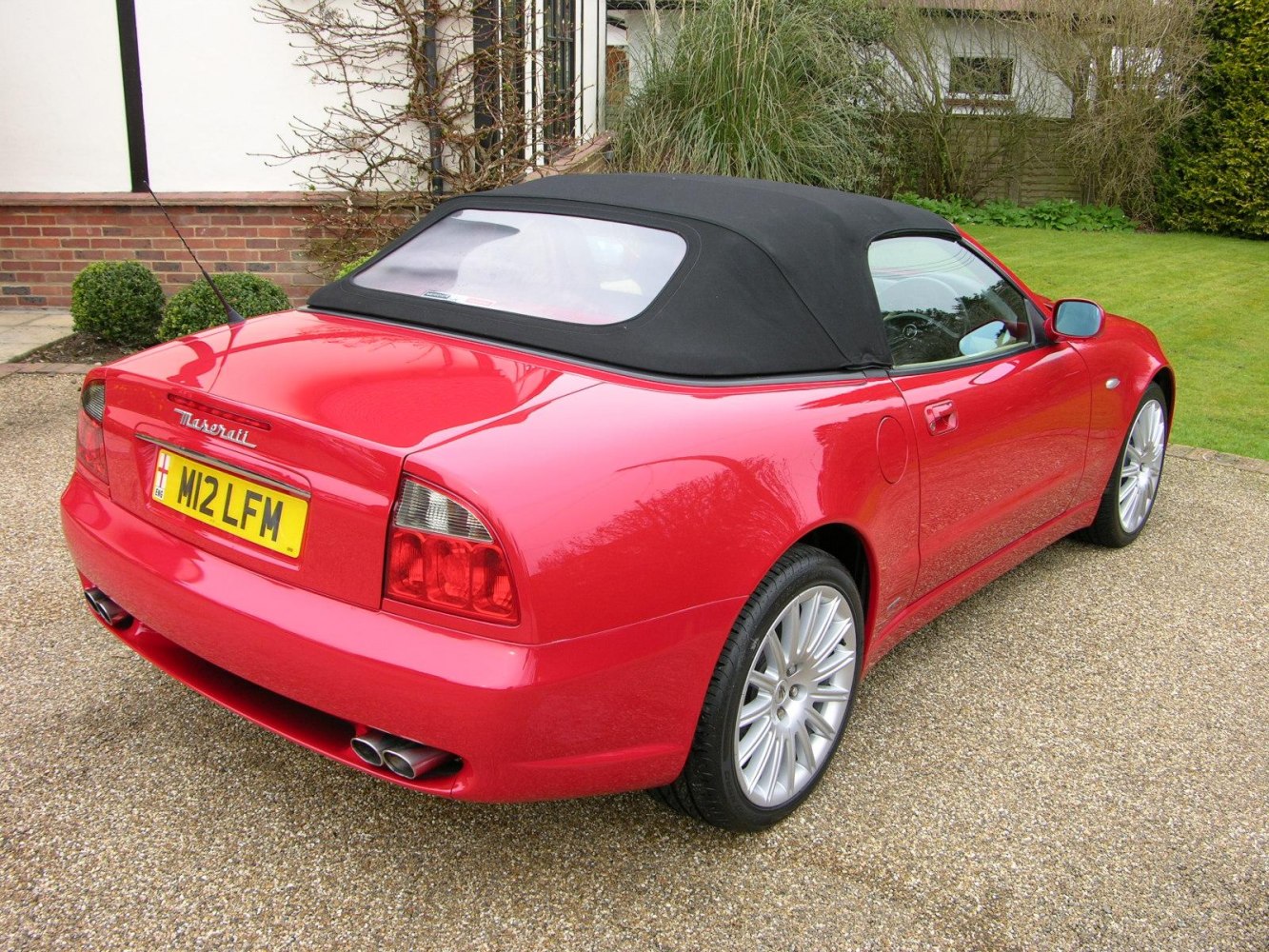 Convertible rear view with soft top and dual exhaust tailpipes
