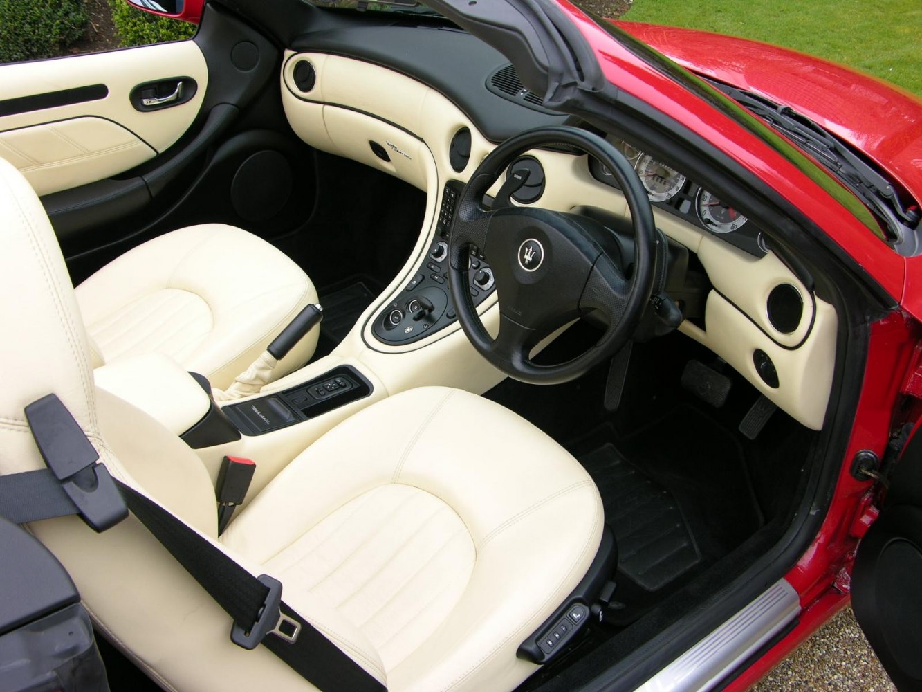 Cream leather seats and sporty dashboard interior.