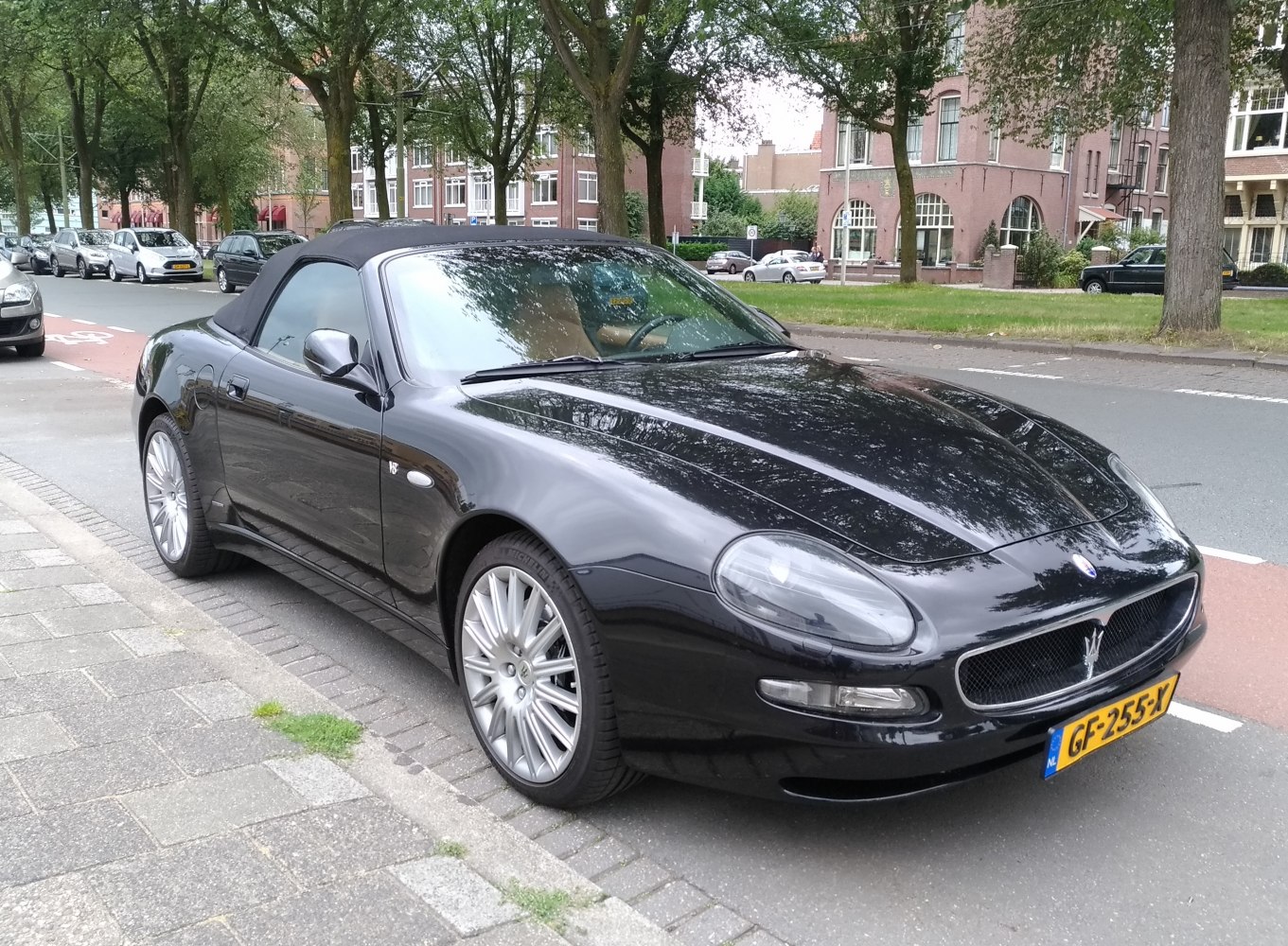 Black convertible with soft top and V8 badge