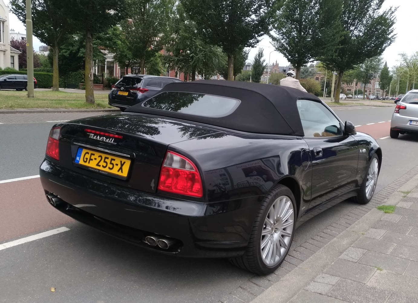 Convertible coupe with soft top roof and quad exhaust