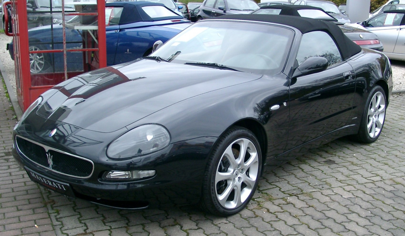Sleek black convertible with V8 badge and alloy wheels