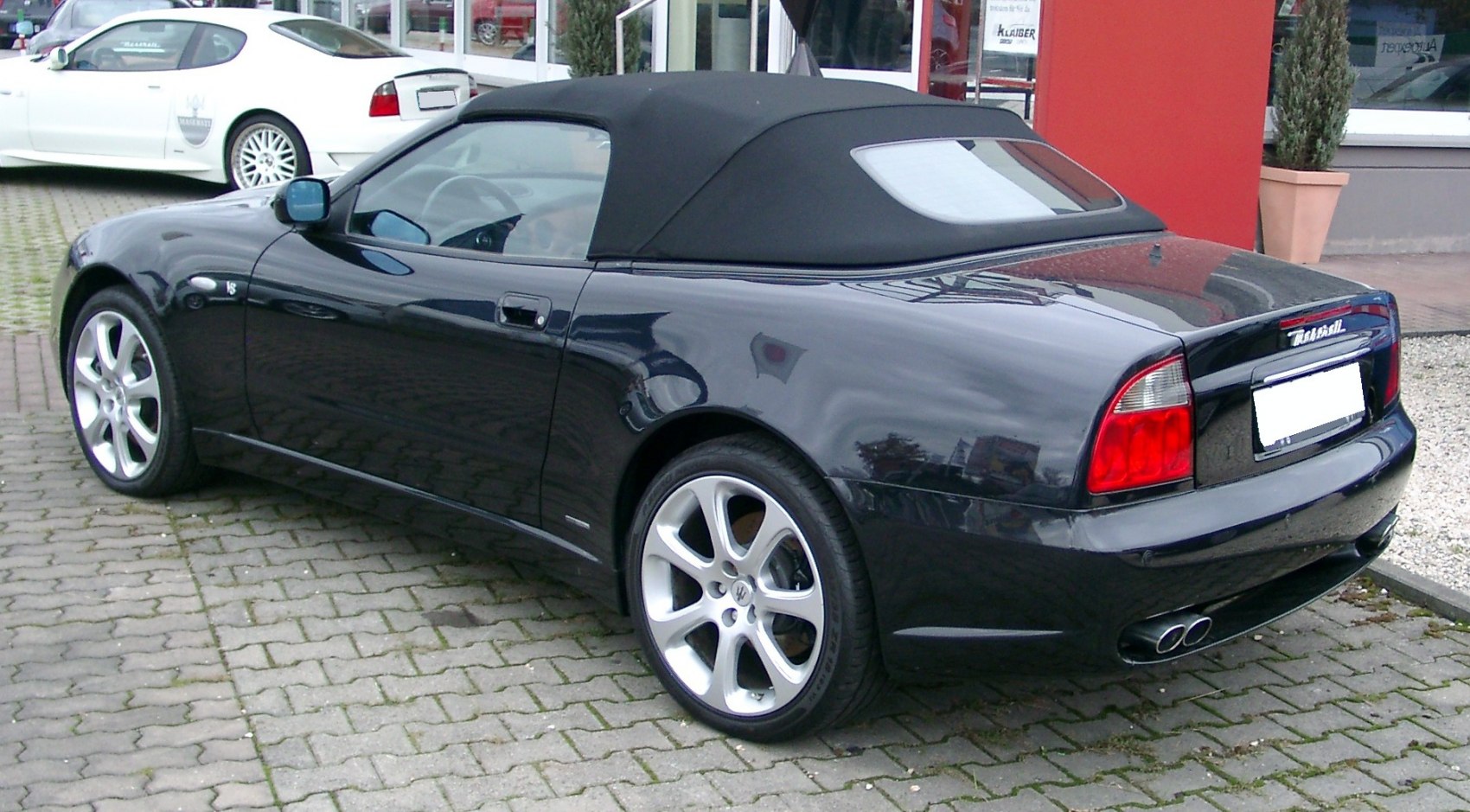 Convertible with soft top roof, rear and side view, dual exhaust