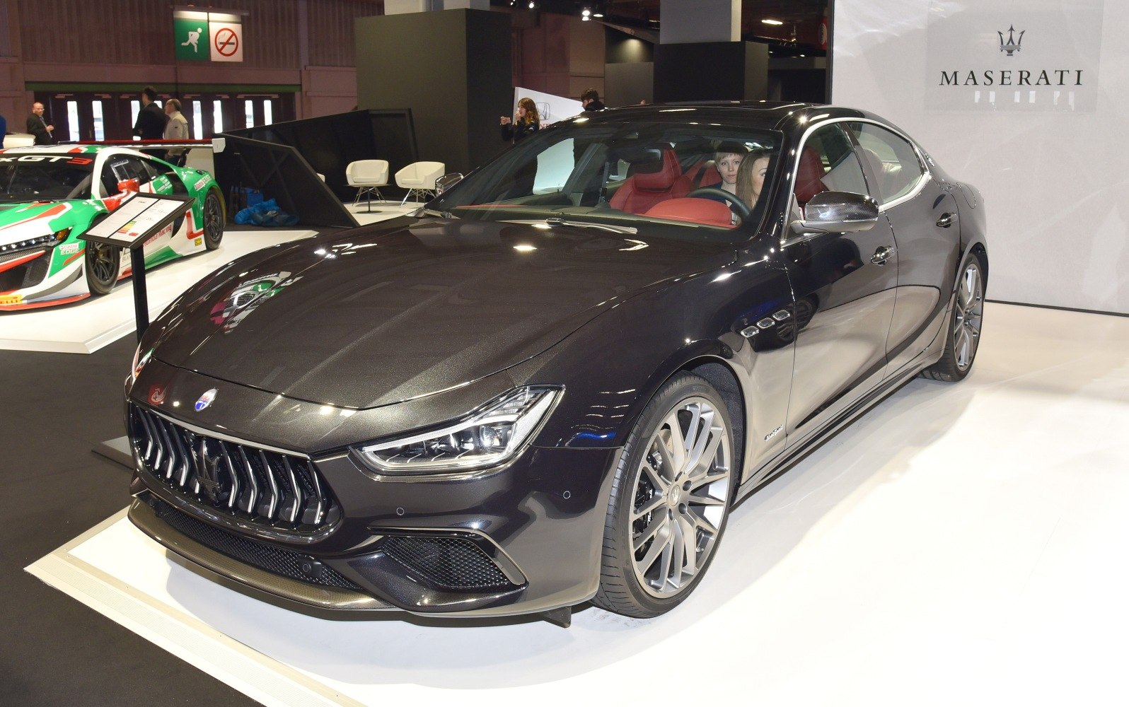 Luxury sedan with sporty grille and sharp headlights, front angled view