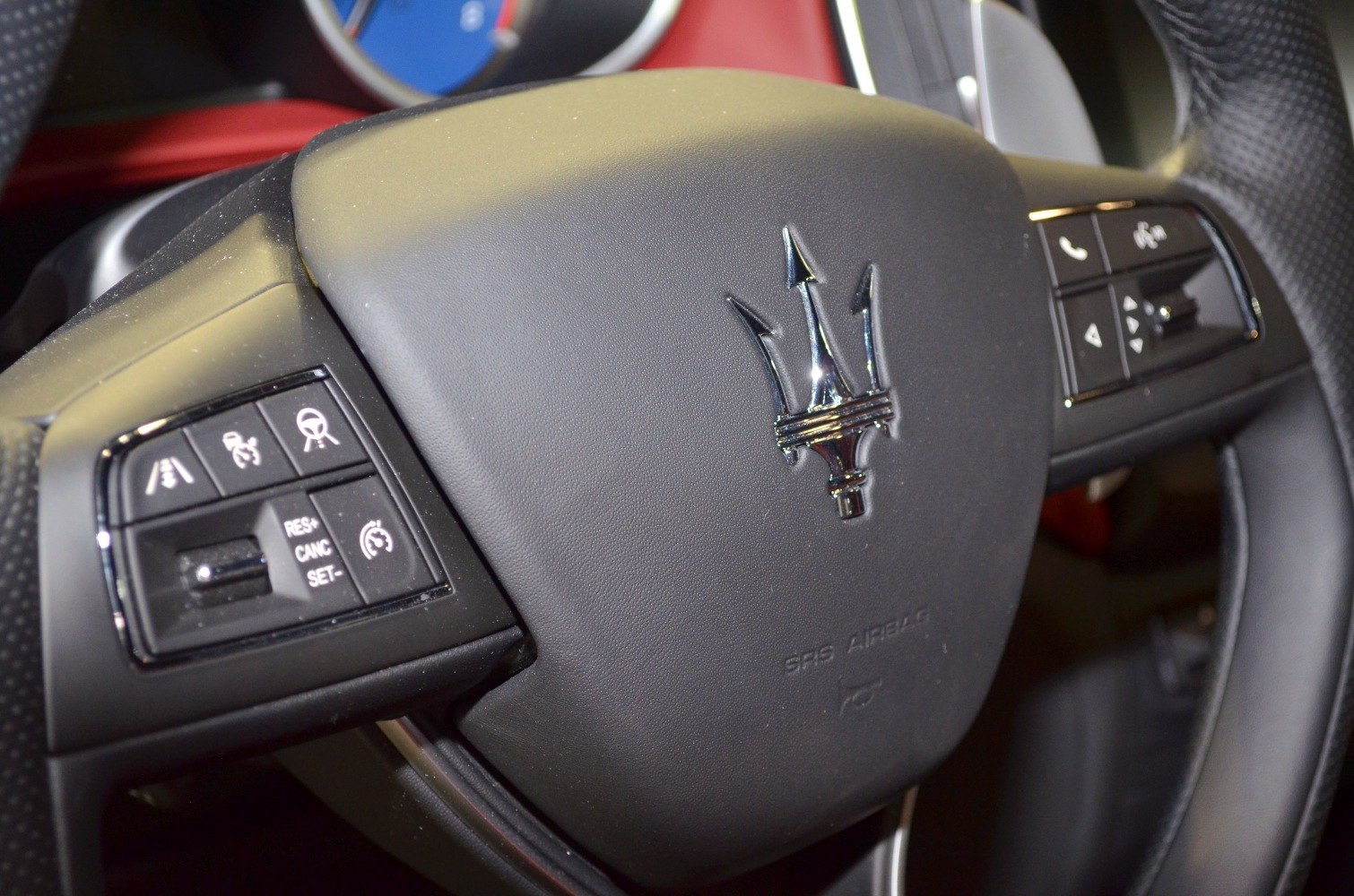 Steering wheel with trident logo and multifunction control buttons