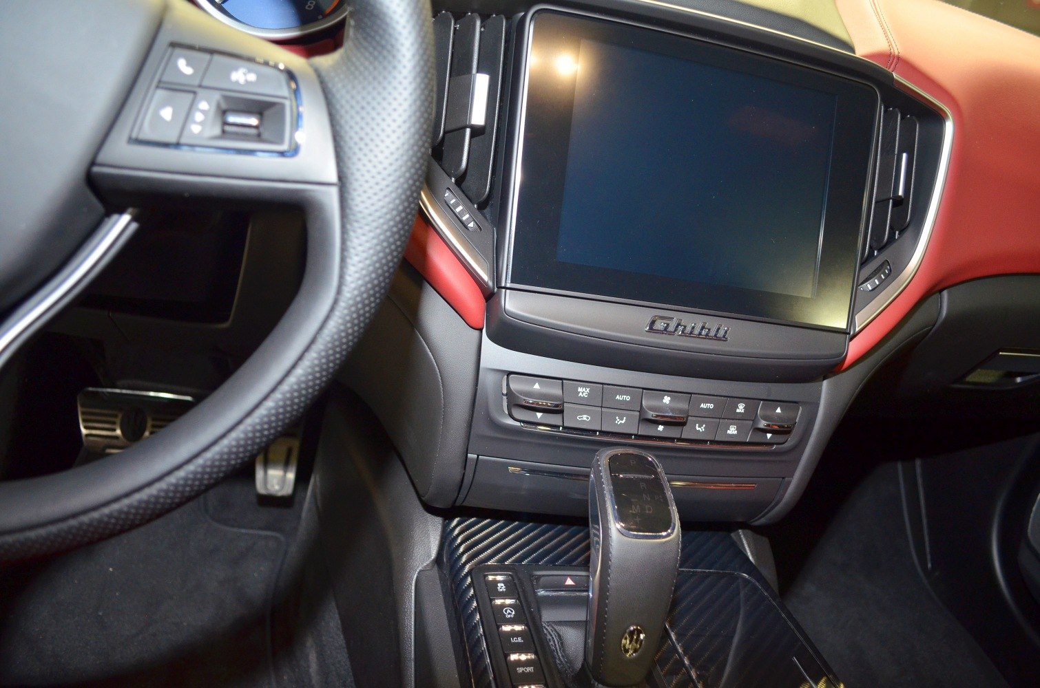 Large touchscreen display with Maserati Ghibli branding and elegant gear shifter