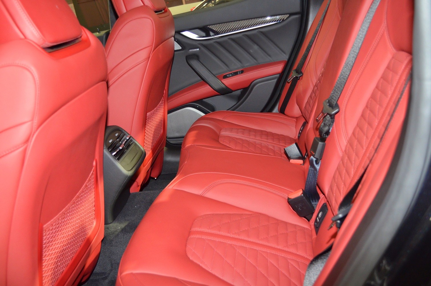 Red quilted leather rear seats with elegant door panel design