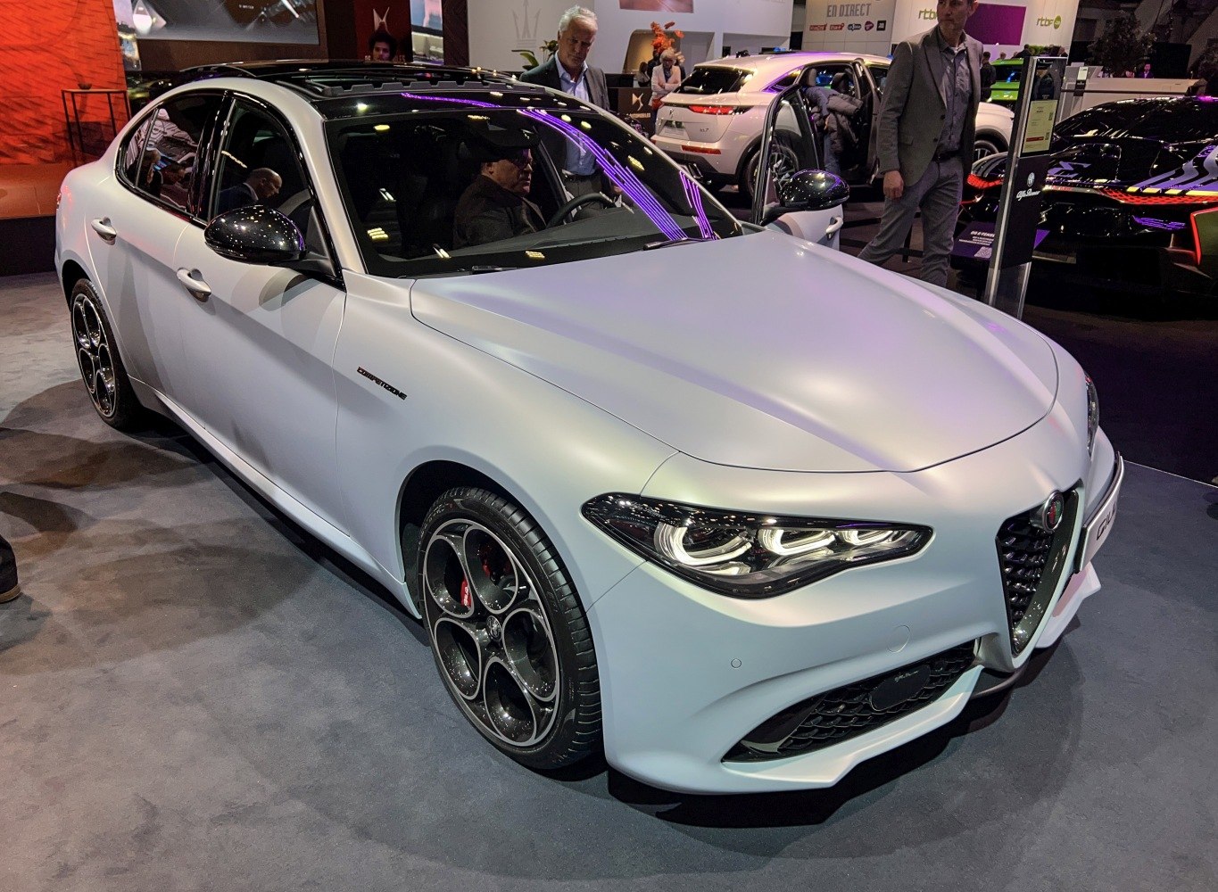 Front angle of a sleek sedan with LED headlights and unique alloy wheels
