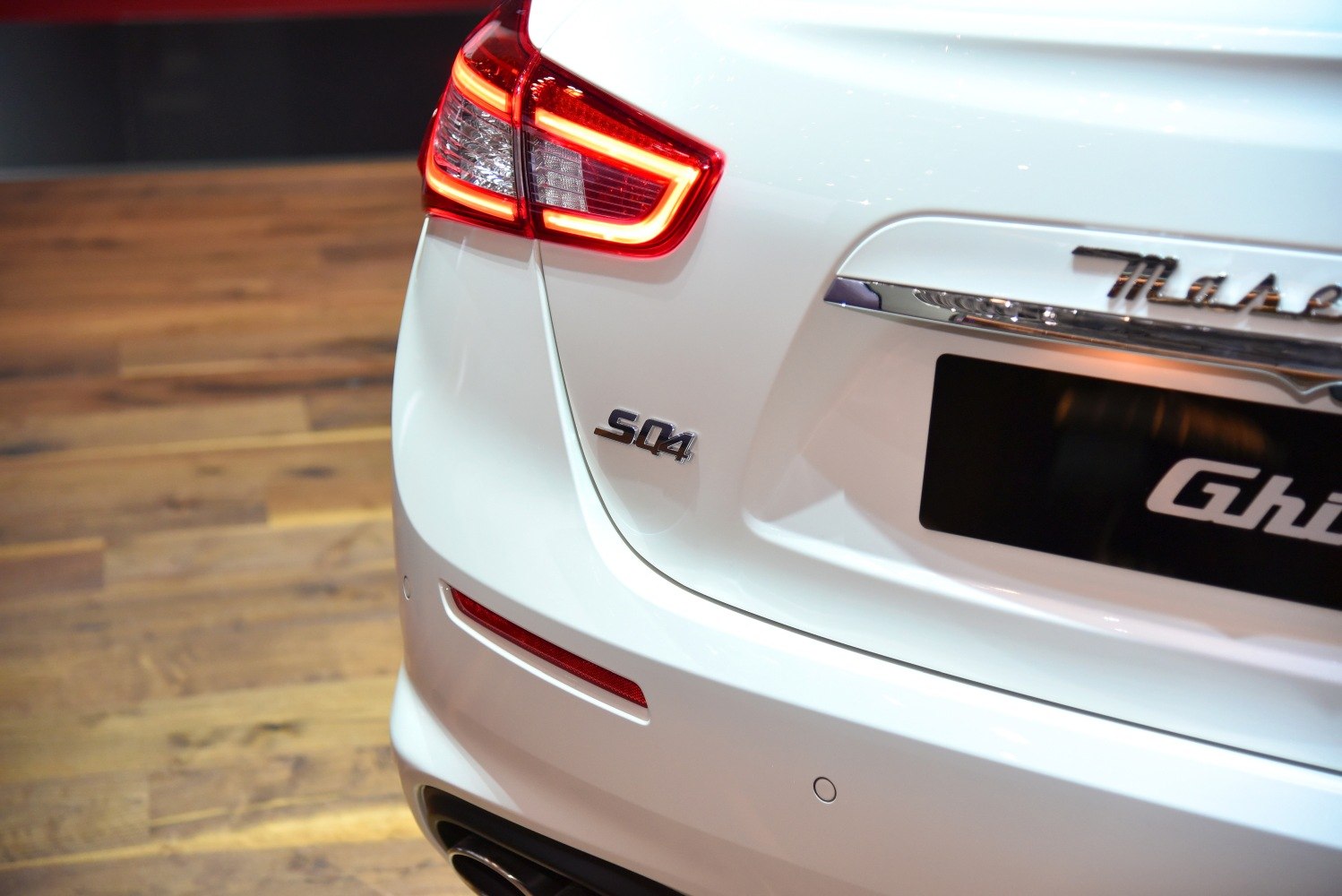 Rear badge and illuminated tail light of a luxury sedan