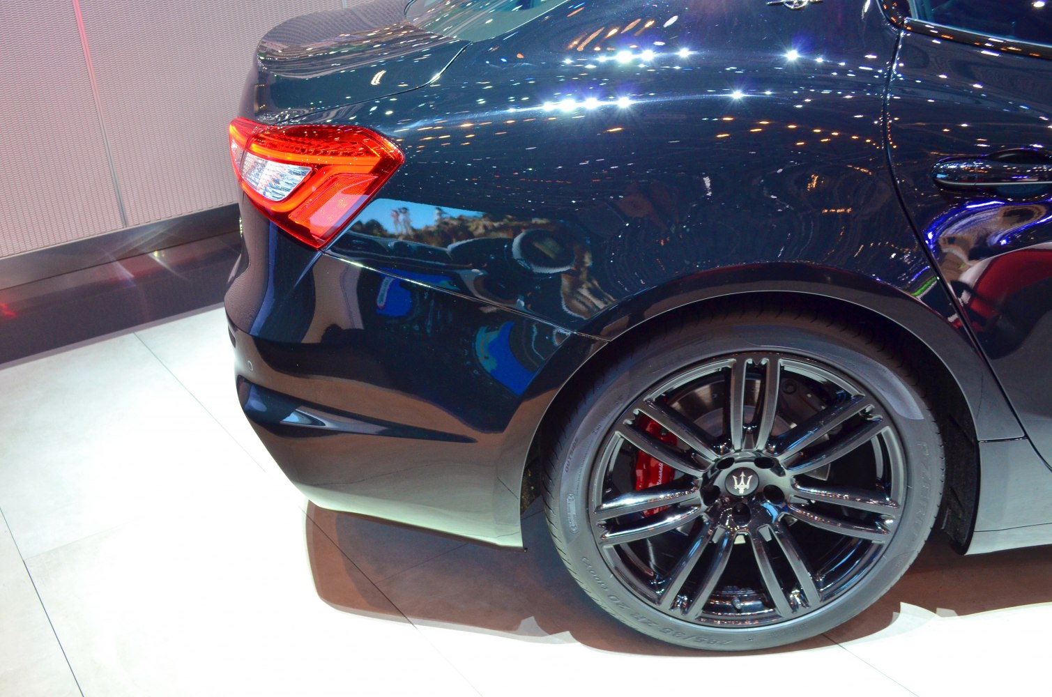 Rear tail light and glossy black multi-spoke alloy wheel with red brake caliper