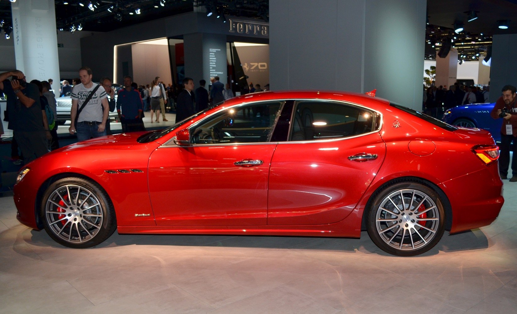 Side profile of red sedan with sporty alloy wheels