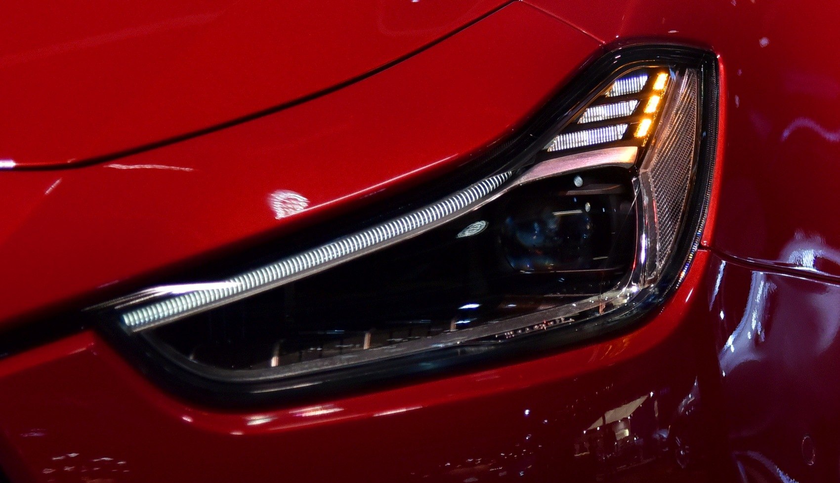 Close-up of a modern LED headlight with sleek design and daytime running lights