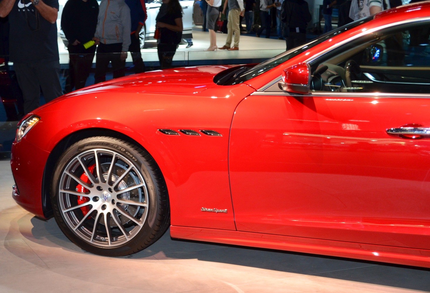 Red car front side with alloy wheel and distinct air vents