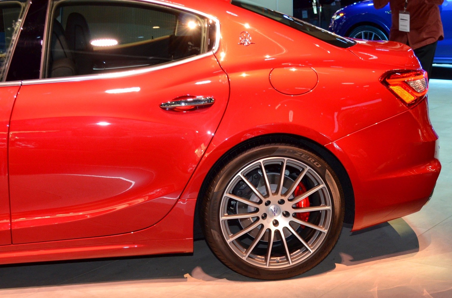 Rear side of the car featuring alloy wheel and red brake caliper