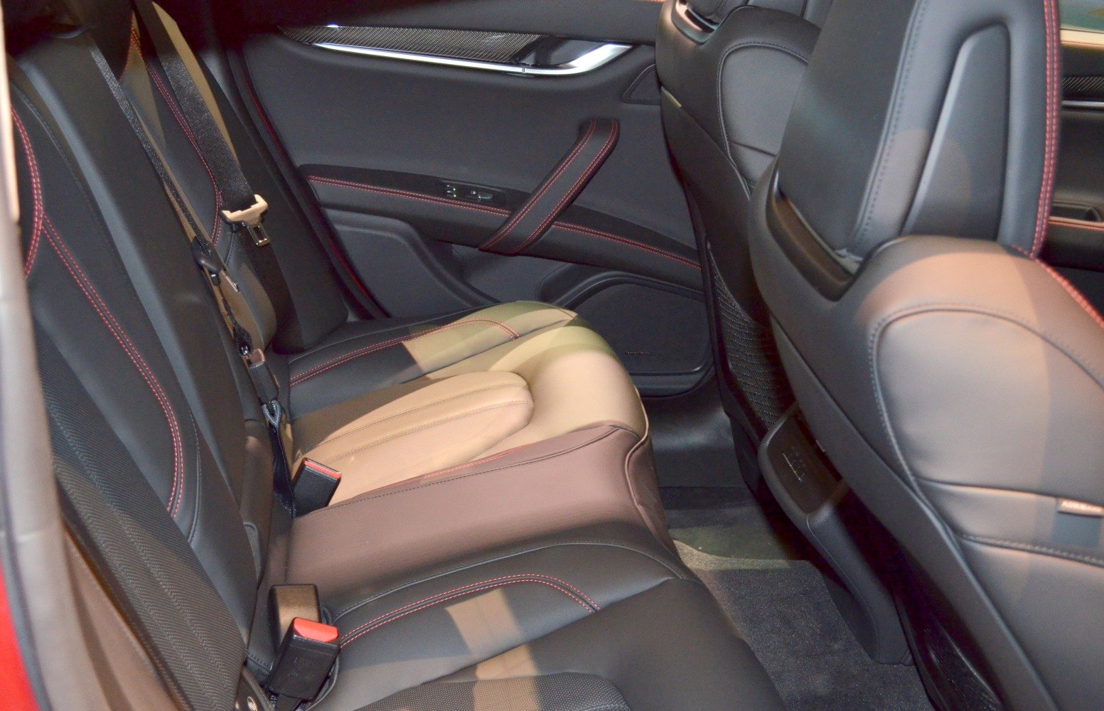 Rear leather seats with red contrast stitching and ergonomic design