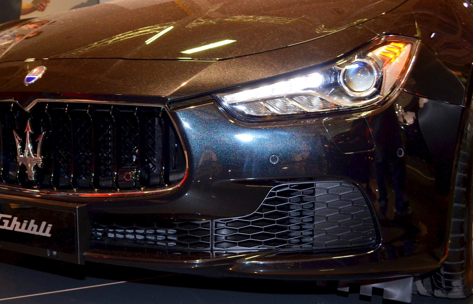 Front grille with Maserati emblem and LED headlight close-up